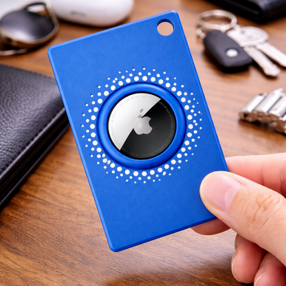 Blue card with a circular design held by a hand on a wooden surface with keys and a wallet.